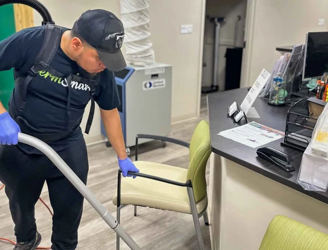 Cleaner wiping glass in a commercial building