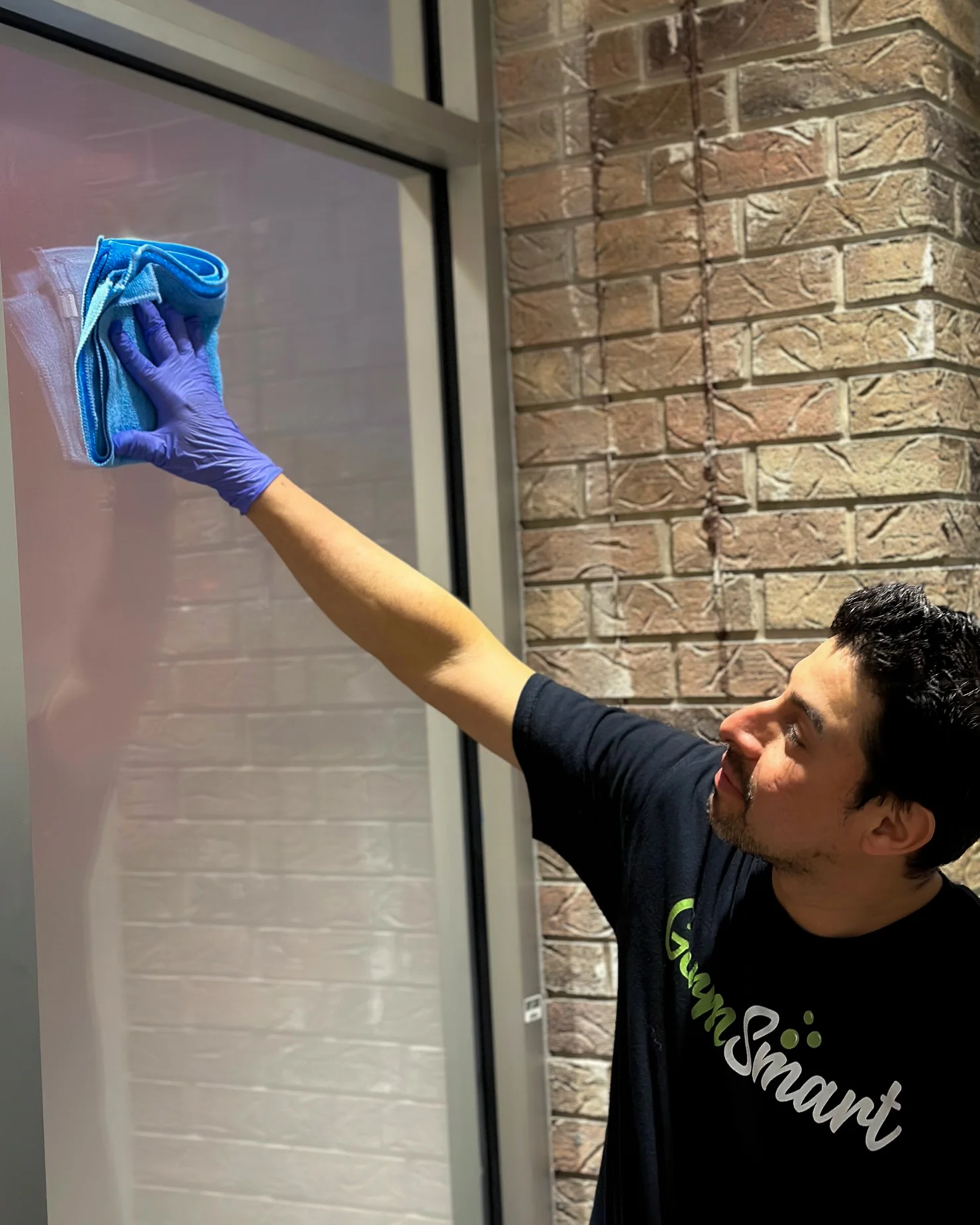 GermSmart cleaner wiping an interior window with a microfiber cloth